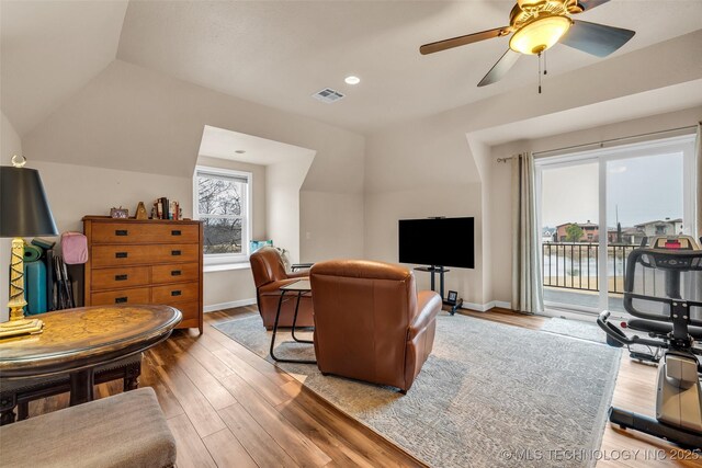 living room featuring lofted ceiling, hardwood / wood-style floors, and ceiling fan