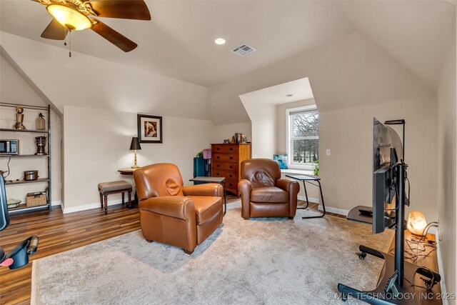 living area featuring lofted ceiling, hardwood / wood-style floors, and ceiling fan