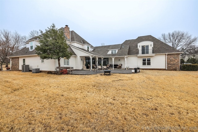 back of house with a yard, central AC unit, and a patio