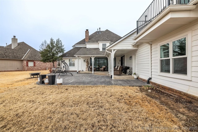 back of house with a patio area and a balcony