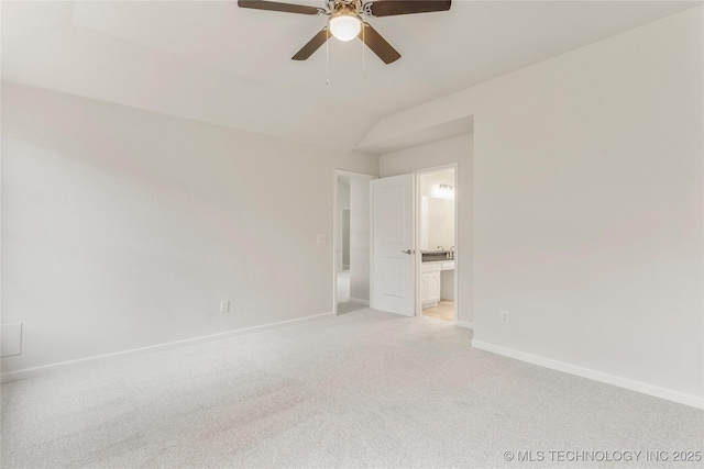 unfurnished bedroom with ceiling fan, lofted ceiling, ensuite bathroom, and light carpet