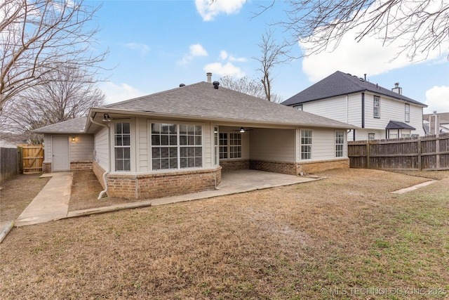 rear view of house featuring a patio, ceiling fan, and a lawn