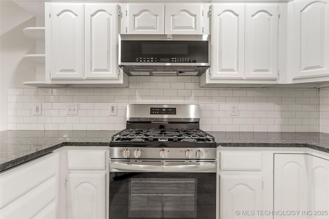 kitchen featuring tasteful backsplash, appliances with stainless steel finishes, dark stone countertops, and white cabinets