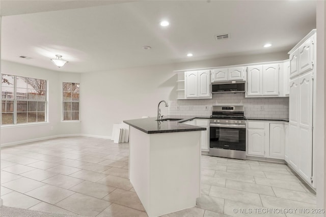 kitchen featuring white cabinetry, sink, decorative backsplash, light tile patterned floors, and stainless steel range with gas stovetop