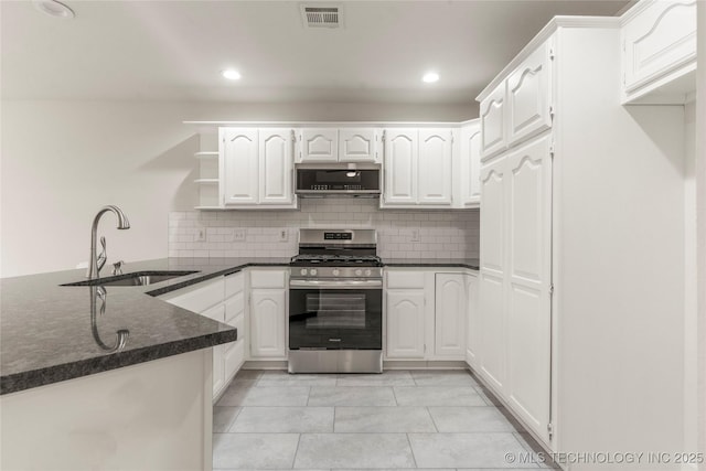 kitchen featuring sink, kitchen peninsula, white cabinets, gas range, and exhaust hood