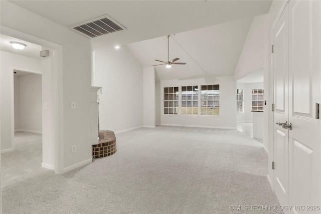 unfurnished living room featuring ceiling fan, lofted ceiling, and light carpet