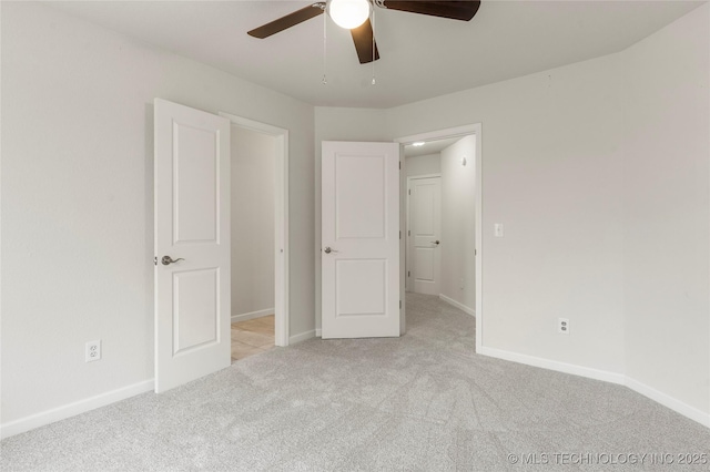 unfurnished bedroom with ceiling fan and light carpet