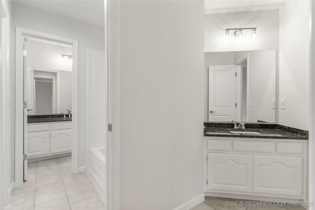 bathroom with vanity, tile patterned floors, and a bathing tub