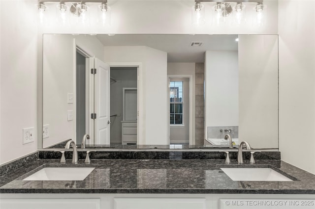 bathroom with vanity and a bathtub