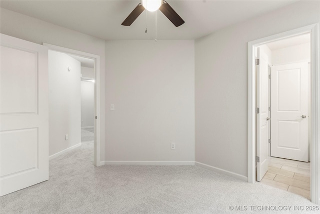 spare room featuring light carpet and ceiling fan