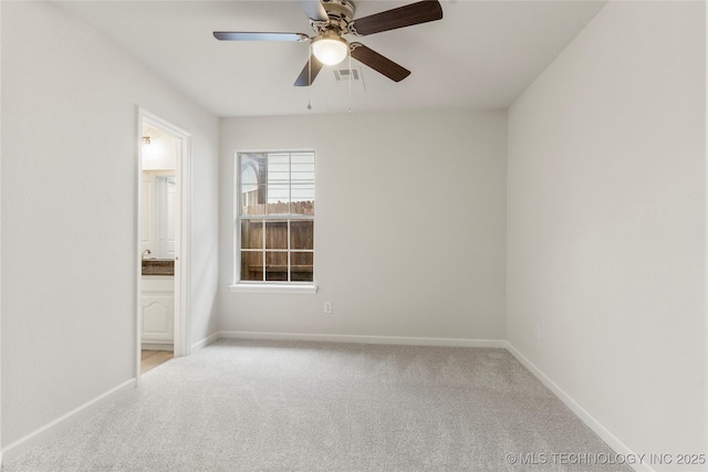 spare room with ceiling fan and light carpet