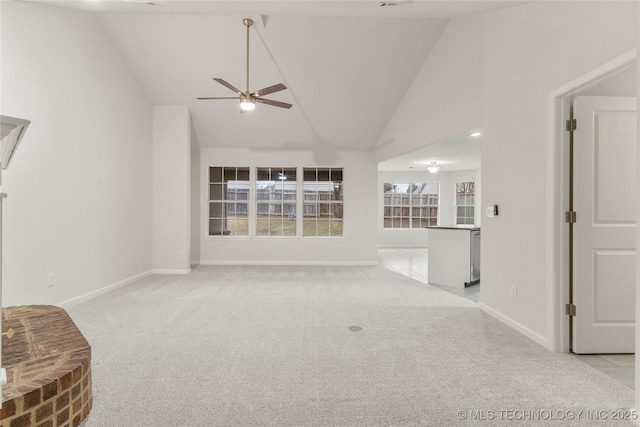 unfurnished living room with high vaulted ceiling, light colored carpet, and ceiling fan