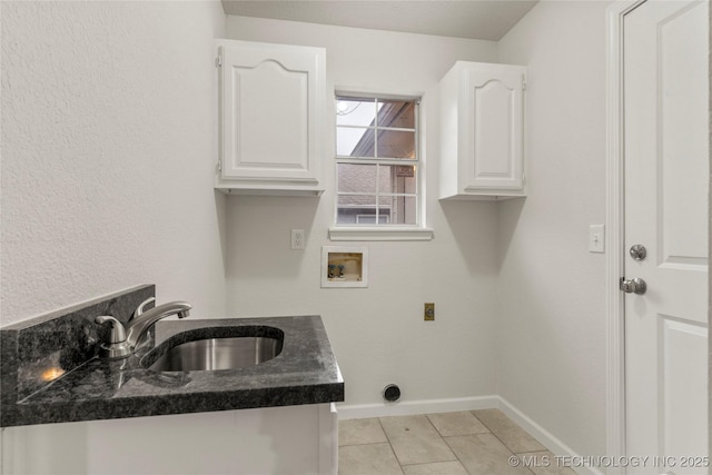 washroom with sink, light tile patterned floors, cabinets, washer hookup, and hookup for an electric dryer