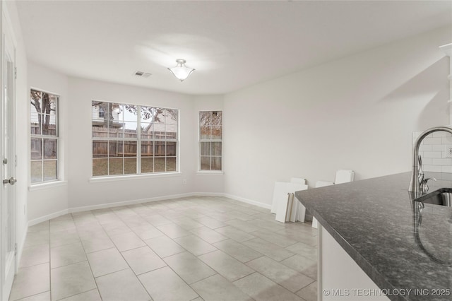 dining room featuring sink and light tile patterned floors