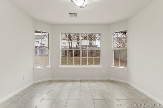 unfurnished dining area featuring light tile patterned floors