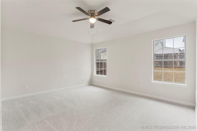 unfurnished room featuring ceiling fan and carpet