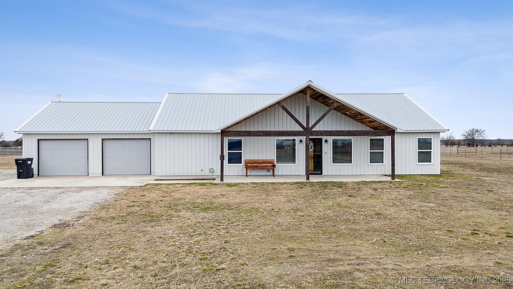 view of front facade with a garage, a porch, and a front lawn