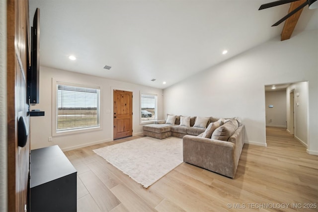 living room featuring lofted ceiling, ceiling fan, and light wood-type flooring