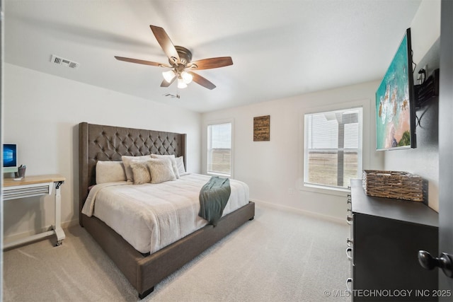 bedroom featuring light colored carpet and ceiling fan