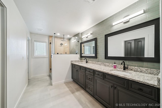 bathroom with vanity and a shower with shower door