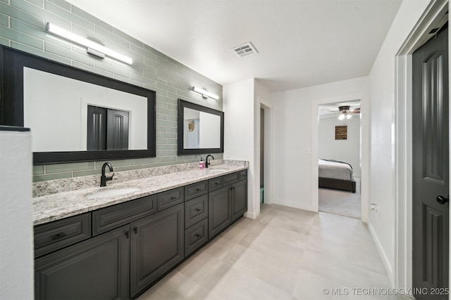 bathroom featuring ceiling fan, vanity, and tile walls