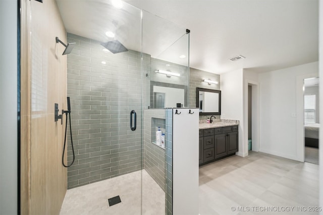 bathroom with vanity and a shower with door