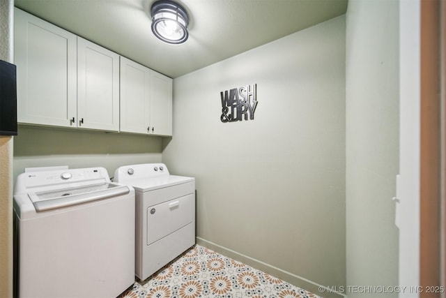 washroom with cabinets and washer and dryer