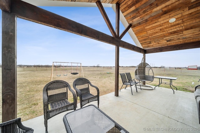 view of patio with a rural view and a playground