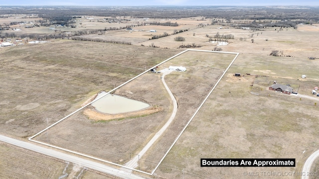 birds eye view of property featuring a rural view