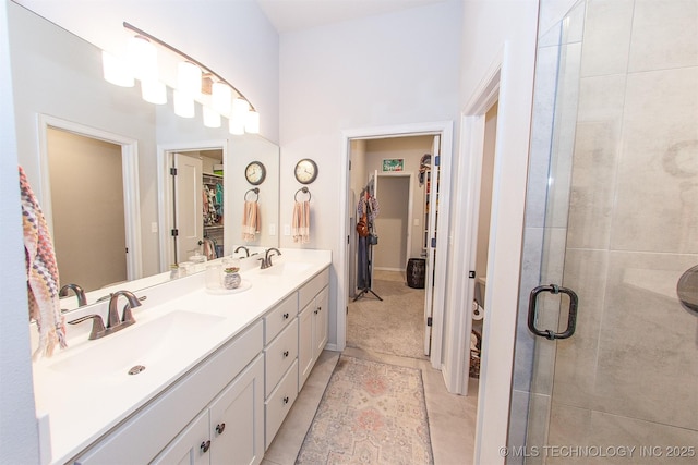 bathroom with tile patterned floors, vanity, and a shower with shower door