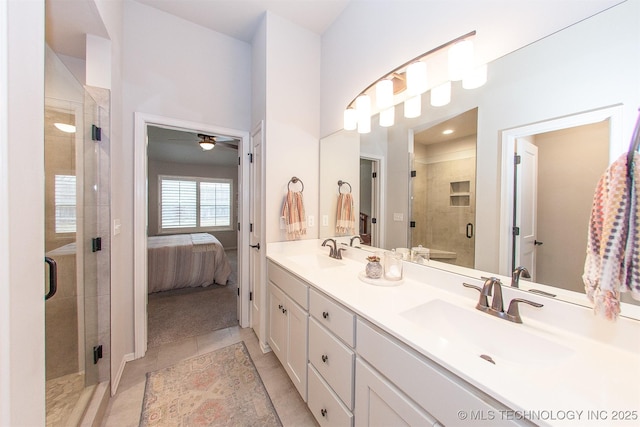 bathroom featuring an enclosed shower, vanity, and tile patterned flooring