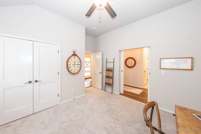 unfurnished bedroom featuring lofted ceiling, light colored carpet, a closet, and ceiling fan