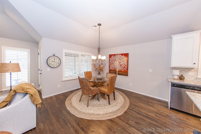 dining space featuring dark hardwood / wood-style flooring, a chandelier, and vaulted ceiling