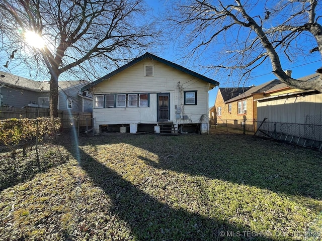 rear view of house with a lawn