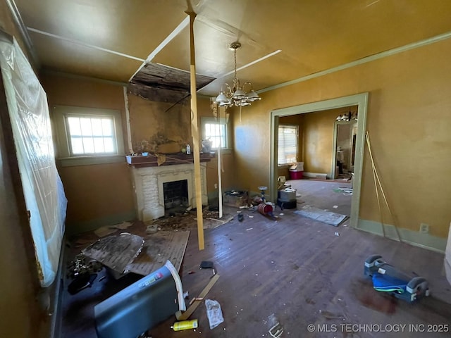 miscellaneous room with ornamental molding, a fireplace, and a chandelier