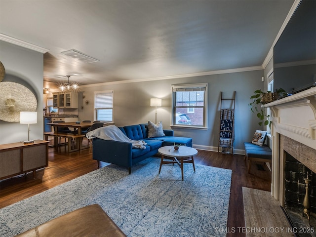 living room featuring dark hardwood / wood-style flooring, crown molding, and a high end fireplace