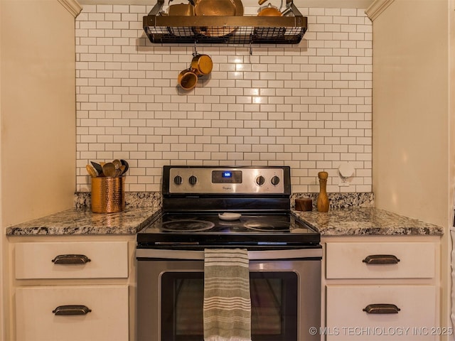 kitchen with light stone counters, extractor fan, tasteful backsplash, and electric range