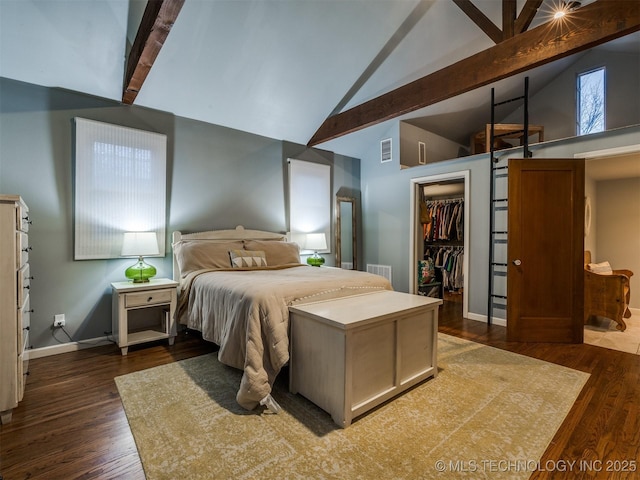 bedroom with beamed ceiling, a walk in closet, high vaulted ceiling, and dark hardwood / wood-style flooring