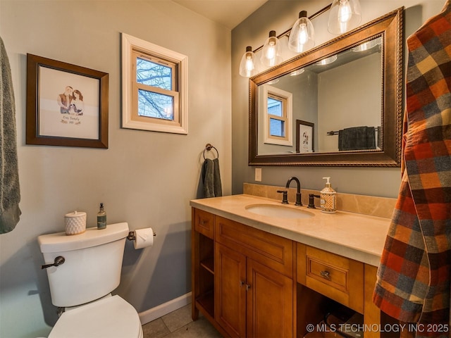 bathroom with tile patterned flooring, vanity, and toilet