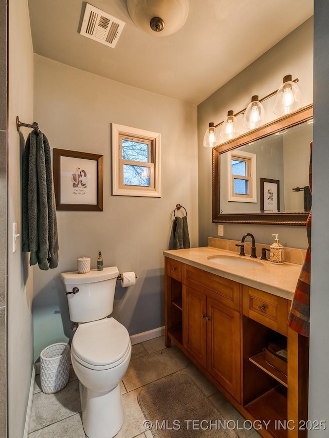 bathroom with vanity, tile patterned floors, and toilet