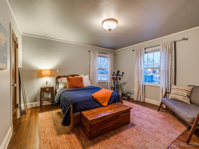 bedroom with dark wood-type flooring and crown molding