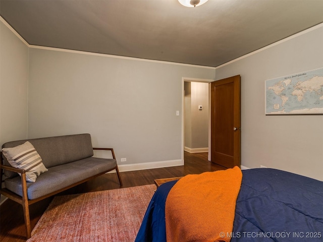 bedroom featuring dark wood-type flooring and crown molding