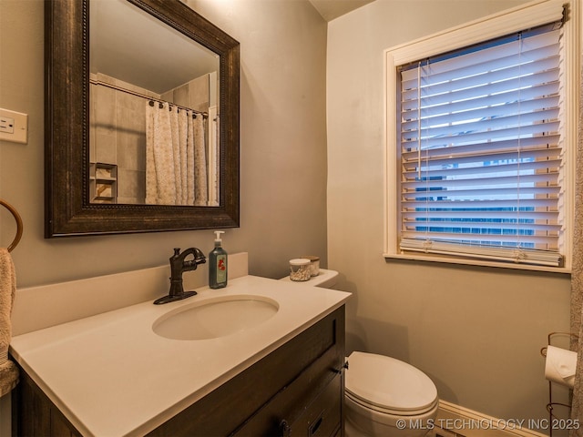 bathroom featuring vanity and toilet