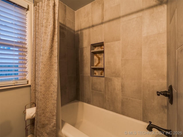 bathroom featuring shower / tub combo with curtain