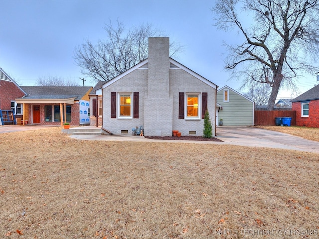 back of house with a yard and covered porch