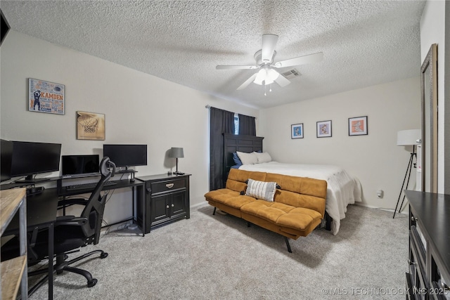 bedroom featuring light carpet, a textured ceiling, and ceiling fan