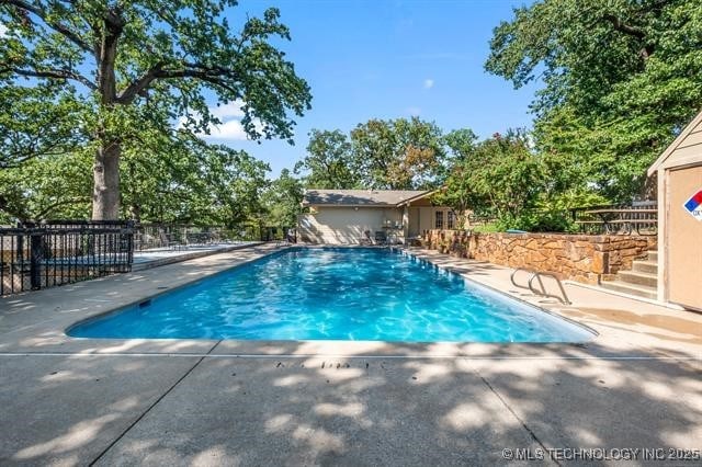 view of swimming pool with a patio area