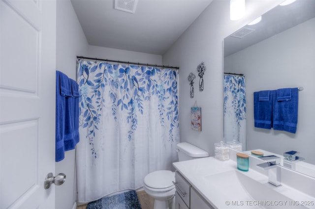 bathroom with vanity, walk in shower, and toilet