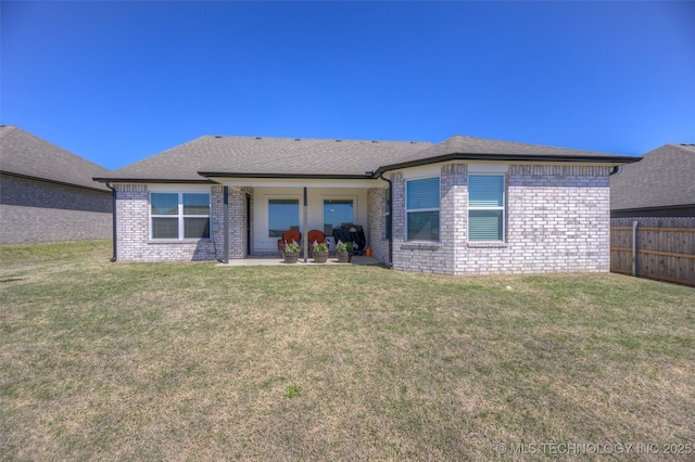 rear view of house with a yard and a patio area