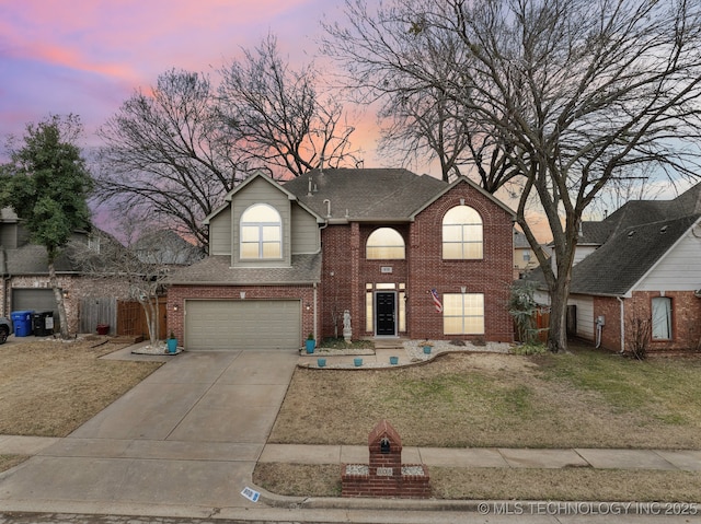 view of front property with a garage and a lawn